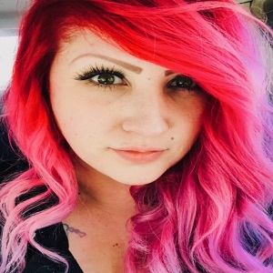 A woman with bright pink hair